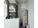 Pictured is the home's HVAC and hot water heater, both easily accessible at 2073 Newtown Rd, Groveland, FL 34736