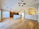 Expansive living room featuring hardwood flooring, neutral paint, and an open layout to the kitchen at 2073 Newtown Rd, Groveland, FL 34736