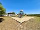 Community playground with slides, ladders, and gazebo surrounded by a sand base at 2073 Newtown Rd, Groveland, FL 34736