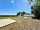 Community playground featuring slides, ladders, and grassy area for play near a fence and gazebo at 2073 Newtown Rd, Groveland, FL 34736