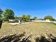 Community playground with slides, ladders, and gazebo on grassy field with scattered trees at 2073 Newtown Rd, Groveland, FL 34736