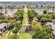 Aerial view showcasing a community park with a playground, benches, and pathways surrounded by lush greenery and residences at 2258 Crystal Falls Way, Orlando, FL 32824