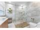 Bathroom featuring marble tiling, glass shower, vanity, and modern finishes at 2258 Crystal Falls Way, Orlando, FL 32824