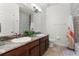 Bathroom with double sink vanity with granite counters and neutral tile walls and floor, bright and functional at 2258 Crystal Falls Way, Orlando, FL 32824