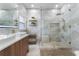 Bathroom featuring marble tiling, glass shower, floating shelves, and modern finishes at 2258 Crystal Falls Way, Orlando, FL 32824