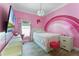 Charming pink bedroom with desk, bed with storage, and accent decor, a personalized, comfortable space at 2258 Crystal Falls Way, Orlando, FL 32824