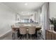 Elegant dining room featuring an opening to the kitchen, a dark wood table, and lovely beige chairs at 2258 Crystal Falls Way, Orlando, FL 32824