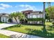 A well-kept home boasting a vibrant green lawn, trimmed shrubs, and a two-car garage on a bright, sunny day at 2258 Crystal Falls Way, Orlando, FL 32824