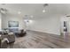 Large living room featuring modern wood floors, recessed lighting, and a comfortable gray sectional sofa at 2258 Crystal Falls Way, Orlando, FL 32824