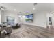 Large living room featuring modern wood floors, a projector, a comfortable couch, and elegant decor at 2258 Crystal Falls Way, Orlando, FL 32824