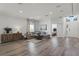 Cozy living room featuring wood floors, modern decor, a gray sectional sofa, and an opening to the foyer at 2258 Crystal Falls Way, Orlando, FL 32824