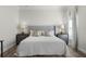 Main bedroom showcasing a tufted headboard, wood flooring, and bedside tables at 2258 Crystal Falls Way, Orlando, FL 32824