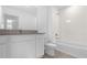 Bathroom with white vanity, tiled floor, and a shower-tub combination with white tile surround at 2306 Lancashire St, Davenport, FL 33896