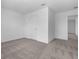 Bright, empty bedroom with plush neutral carpet, white walls and trim, and a walk-in closet at 2306 Lancashire St, Davenport, FL 33896