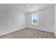 Cozy bedroom with neutral carpet, white walls, and a window letting in natural light at 2306 Lancashire St, Davenport, FL 33896