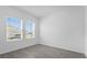 Bright bedroom features wood-look flooring and natural light streaming through two windows at 2306 Lancashire St, Davenport, FL 33896