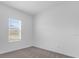 Neutral bedroom with a window with blinds and plush carpet flooring at 2306 Lancashire St, Davenport, FL 33896