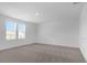 Bright bedroom featuring neutral carpet, white walls, and natural light from the double window at 2306 Lancashire St, Davenport, FL 33896