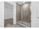 Modern shower with glass door and a tiled surround, with a view to the walk-in closet at 2306 Lancashire St, Davenport, FL 33896