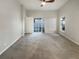 Large bedroom with sliding glass doors, ceiling fan, neutral walls, and cozy carpet at 2350 Blue Sapphire Cir, Orlando, FL 32837