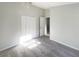 A bright bedroom with closet and a door, plus neutral walls and carpet at 2350 Blue Sapphire Cir, Orlando, FL 32837