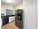 This modern kitchen boasts black appliances, white cabinets, a double door refrigerator, and black countertops at 2350 Blue Sapphire Cir, Orlando, FL 32837