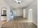 Open-concept living room showcases hard surface flooring, arched doorways, and a view into the kitchen area at 2350 Blue Sapphire Cir, Orlando, FL 32837