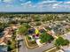 An aerial view of the property showcases its location within a neighborhood of similarly sized houses with mature trees at 2821 Lone Feather Dr, Orlando, FL 32837