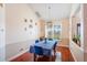 Well-lit dining room showcasing hardwood floors, neutral paint, and wainscoting at 2821 Lone Feather Dr, Orlando, FL 32837