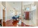 Elegant dining room showcasing hardwood floors, a stylish light fixture, and a view into the tiled foyer at 2821 Lone Feather Dr, Orlando, FL 32837