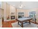 Cozy living room featuring a fireplace, pool table, and access to the outdoor pool area at 2821 Lone Feather Dr, Orlando, FL 32837