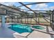 Sparkling pool and spa with covered lanai and outdoor grilling area at 2821 Lone Feather Dr, Orlando, FL 32837