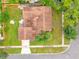 Aerial view of a well-maintained home showcasing the roof, driveway, and the surrounding green lawn at 3052 Saratoga Dr, Orlando, FL 32806