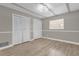 Bedroom featuring wood flooring, neutral walls, closet with folding doors and a window at 3052 Saratoga Dr, Orlando, FL 32806