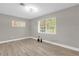 Bedroom featuring wood flooring, neutral walls, and windows with blinds for natural light at 3052 Saratoga Dr, Orlando, FL 32806