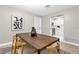 Dining room with wooden table, modern decor, and an open view into the kitchen at 3052 Saratoga Dr, Orlando, FL 32806