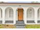 Close up of the front door of a white house with arched windows and porch at 3052 Saratoga Dr, Orlando, FL 32806