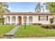 Charming single story house with an arched porch and well-manicured lawn at 3052 Saratoga Dr, Orlando, FL 32806