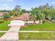 Charming single-story home with a spacious front yard, attached garage, and mature palm trees at 3052 Saratoga Dr, Orlando, FL 32806