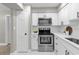 Clean white kitchen features modern appliances, subway tile backsplash, and a neutral color palette at 3052 Saratoga Dr, Orlando, FL 32806