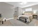 Main bedroom featuring a bed with decorative pillows and a wooden bench at 3052 Saratoga Dr, Orlando, FL 32806