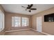 Empty bedroom with two windows with shutters and a ceiling fan at 316 Trieste Loop, Lake Mary, FL 32746