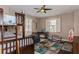 Cozy bedroom featuring a wooden bunk bed, ceiling fan, and bright windows with plantation shutters at 316 Trieste Loop, Lake Mary, FL 32746