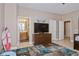 bedroom with colorful rug, flatscreen TV and dresser, connecting door to bathroom, and tiled flooring at 316 Trieste Loop, Lake Mary, FL 32746