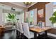 Elegant dining area with modern table setting, stylish chairs, decorative wall accents, and sunlit windows at 316 Trieste Loop, Lake Mary, FL 32746