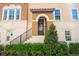 Inviting entrance with covered porch, black front door, and neat landscaping, offering great curb appeal at 316 Trieste Loop, Lake Mary, FL 32746