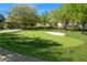 Community putting green surrounded by mature trees and lush landscaping at 316 Trieste Loop, Lake Mary, FL 32746