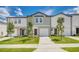 Inviting townhomes with manicured lawns, sidewalks, and attached garages at 3483 Vesara Dr, Davenport, FL 33837