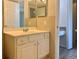 Bathroom featuring a white vanity with a marble countertop and neutral-toned tiling at 3772 Idlebrook Cir # 210, Casselberry, FL 32707