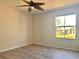 Bedroom showing a window that provides natural light and wood-look laminate flooring at 3772 Idlebrook Cir # 210, Casselberry, FL 32707